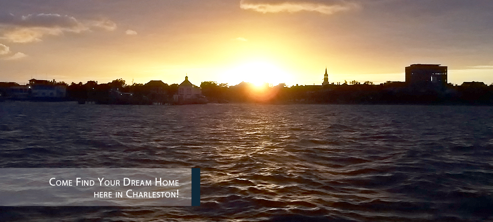 A sunset over the water with a church in the background.