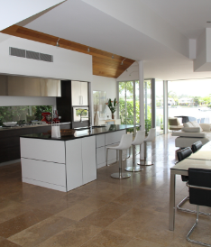 A kitchen with a large island and white cabinets.