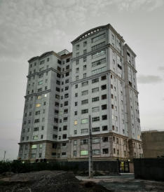 A tall building with many windows on the top of it.